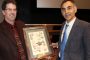 Dr. Chaitan Khosla of Stanford University (right), is presented with a plaque by Dr. Andrew C. Hillier, chair of Iowa State's Department of Chemical and Biological Engineering. Khosla spoke at Iowa State as part of the Chemical and Biological Engineering Department's L.K. Doraiswamy Honor Lectureship Series.