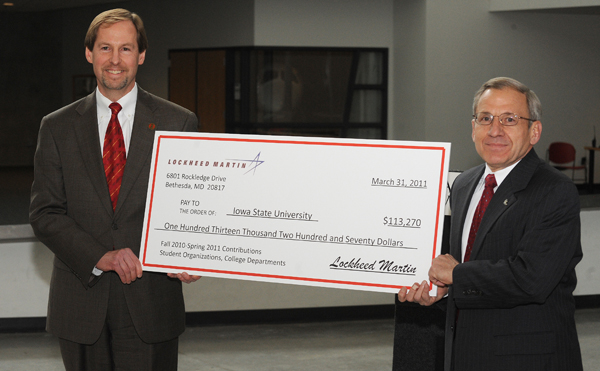 Neil Kacena, right, vice president of advanced development programs with Lockheed Martin, presents a check to College of Engineering Dean Jonathan Wickert.