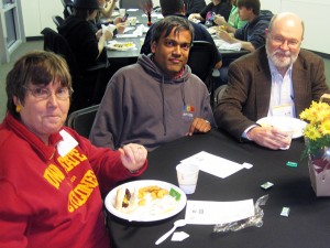 A picture of Gloria Cain, Simanta Mitra, and Jim Jones dining at the competition.