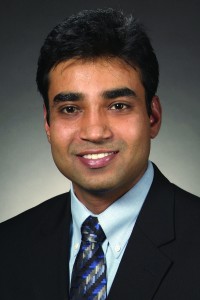 Professional headshot photo of Santosh Pandey, smiling at the camera and wearing a suit and tie