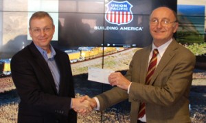 Rick Holmes (left) presents the check to David Jiles (right)