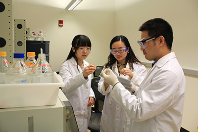 From left: Chemical and biological engineering doctoral student Meirong Gao, Assistant Professor Zengyi Shao, and postdoctoral research associate Mingfeng Cao analyze mix-sugar utilization of yeast consortium using high-performance liquid chromatography.