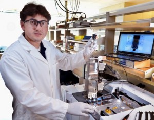 Juan Proano Aviles, an Iowa State doctoral student in mechanical engineering, uses a micropyrolyzer to simulate the thermal and chemical behavior of biomass as it’s processed into bio-oil. Photo by Bob Elbert.