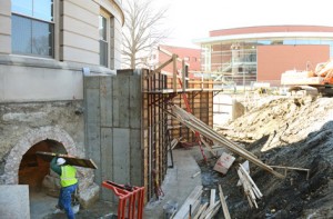 Poured concrete walls on the west side will protect the building's new below-grade electrical transformer and switchgear.