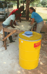 Used, 45-55 gallon food containers (yellow barrel) store grains in hermetic system. Photo by Richard Schultz, College of Agriculture and Life Sciences.