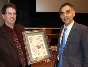 Dr. Chaitan Khosla of  Stanford University (right), is presented with a plaque by Dr. Andrew C. Hillier, chair of Iowa State's Department of Chemical and Biological Engineering. Khosla spoke at Iowa State as part of the Chemical and Biological Engineering Department's L.K. Doraiswamy Honor Lectureship Series.