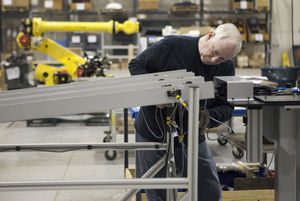 Lauren Cullen, an electrician at Acieta, sets up the preliminary stage of a project inside the industrial automation robotics company's facilities on March 24. (Staff photo/Joe Shearer)