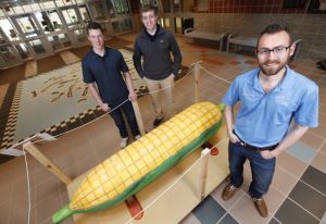 Engineers Without Borders-ISU will auction the folk art coffin by Eric Adjetey Anang to help fund an earthen dam in Ghana. From left, engineering students Kevin Strohm, Jason Schmitt and Joe Gettemy. (Photo by Christopher Gannon)