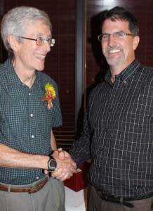 Glatz (left) is congratulated by Dr. Andy Hillier, Department of Chemical and Biological Engineering chair, at his farewell reception. Glatz hired Hillier in 2003 when he was department chair.