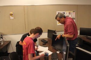 Senior lecturer Simanta Mitra coaches team members Tyler Uhlenkamp, senior in software engineering, and Jacob Smith, freshman in software engineering, for a computer programming contest. The team will travel to Marrakech, Morocco to compete against 127 teams from around the world. 
