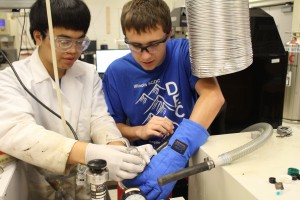 Ames High School student Nathan Chen (left) works on a project with CBE scientist Austin Hohmann