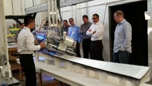 Siqi Zhu, Ph.D. candidate in the Department of Industrial and Manufacturing Systems Engineering, demonstrates the automated fabric layup machine in the Wind Energy Manufacturing Laboratory