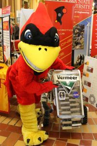 Cy poses with the space mining rover students from the ISU Cyclone Space Mining Club created. 