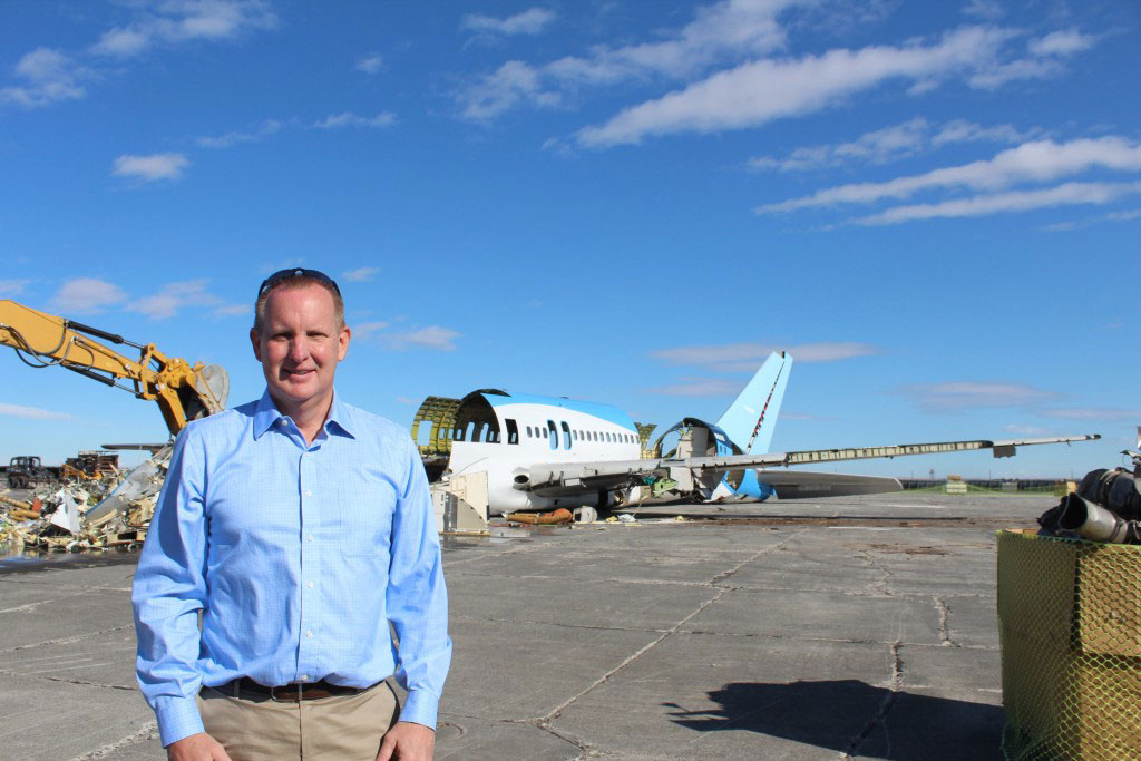 Christensen in front of the 757 ecoDemonstrator being dismantled during the aircraft recycling process. 