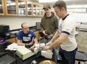 University of Northern Iowa students Chris Reilly, left, Ben Beck, center, and Brad Friend, right, test background radiation during a physics lab class in Begeman Hall Thursday, March 8, 2012, in Cedar Falls, Iowa. (Matthew Putney, Waterloo Courier)