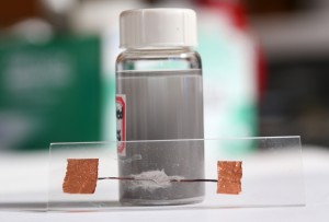 The vial contains liquid-metal particles suspended in ethanol. The particles were used to demonstrate heat-free soldering.