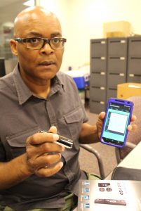 Bluetooth technology plays a key role in Rollins' plan. Here he holds the type of Bluetooth transmitter that could send blood glucose analysis to a phone.