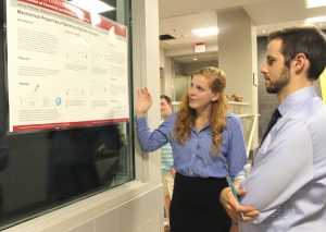 CBE student Jamie Pryhuber discuses the research poster she will present at the AIChE conference in San Francisco with CBE's Dr. Nigel Reuel.