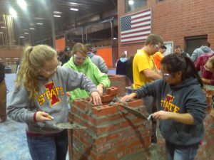 Penton (right) and team members design top of campanile during masonry activity (Photo courtesy Brad Perkins)