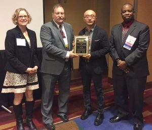 CBE's Herbert L. Stiles Professor of Chemical and Biological Engineering Yue Wu (second from right) receives the Young Investigator Award at the American Institute of Chemical Engineers Annual Meeting.