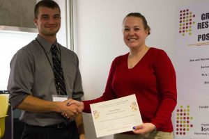 Ophoff (left) earns first place in the Exhibition Showcase category at the Sixth Annual CCEE Graduate Student Research Showcase and Poster Competition. Dr. Jennifer Shane (right) giving award. (Photo by Kate Tindall)