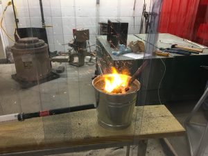 The students crafted their own forge using a bucket. 