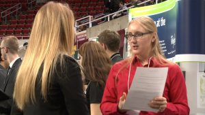 Iowa County Engineers Association representative talks to student (Photo by Tindall)