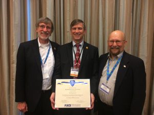 Giroux (center) accepts the Roebling Award at ASCE's Construction Research Council. ISU Construction Engineering Program Professor-in-Charge Chuck Jahren (left) and ISU Construction Engineering Professor Doug Gransberg (right) accompany him. <i> Photo courtesy Paul Giroux </i>