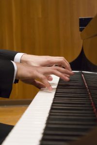 A close-up at Hu's hands while he plays (Photo by Kate Tindall)