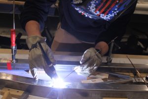 Student welds together parts of steel bridge (Courtesy Joni Truong)