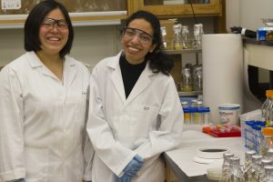 Ikuma (left) and Da'Er prior to research in their environmental engineering laboratory. <i>(Photos by Kate Tindall).</i>