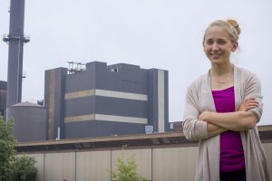 Kristen Cetin stands in front of the Iowa State University Power Plant. Her research on energy production would impact facilities like this one during times of peak usage. <i> Photo by Kate Tindall. </i>