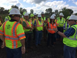 Williams (front right) addresses a group during the Aug. 28 laying of a high RAP section of asphalt pavement. <i> Photos courtesy Bill Rosener, APAI. </i>