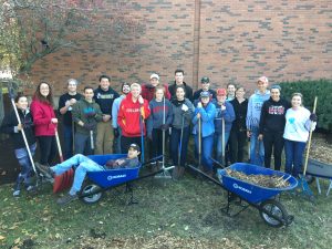 Student members of Engineers for a Sustainable World (ESW), along with friends, gather up for a group photo during Sunday's compost project. <i> Photos by Kate Tindall. </i>