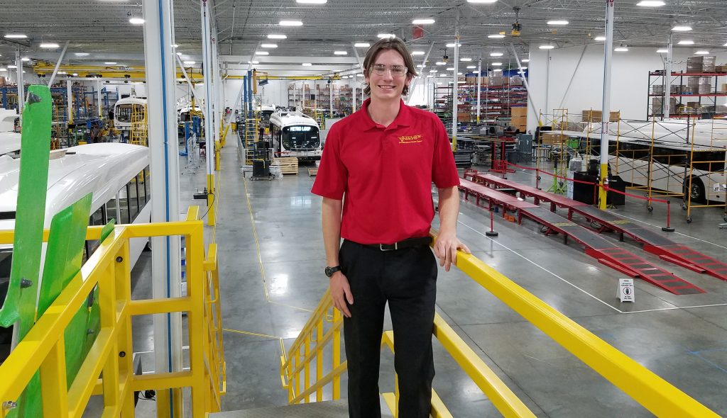 Mechanical engineering senior Ryan Saunders poses at the Proterra electric bus company headquarters in Greenville, South Carolina