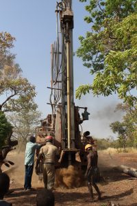 A local contractor drills a borehole for a mechanized well.