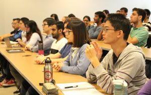 Students in auditorium watch presentation