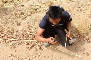 Kylar Oh completes surveying work for the group’s water distribution project.