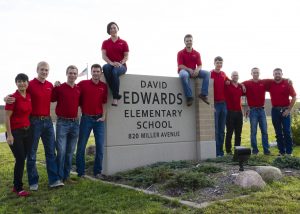 Senior Lecturer Beth Hartmann (left) stands with Cyclone Energy, a student organization that competes the National Electrical Contractors Association Green Energy Challenge each year. Teams submit electrical construction management proposals suggesting improvements to electrical systems in local structures. The team has won numerous national championships.