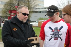 Senior Lecturer Brad Perkins (left) teaches a hands-on construction engineering course to students on ISU's campus. 