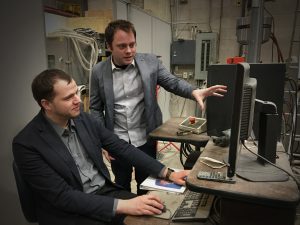 Downey <i>(right)</i> and Laflamme discuss research in ISU CCEE's structural engineering laboratory. <i>Photo by Tindall.</i>