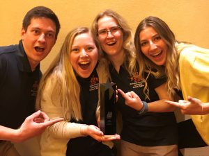 McLaren, Taylor, Gronewold, and Shah have some fun after winning their Student Chapter of the Year trophy. <i> Photos courtesy ISU MCA. </i>