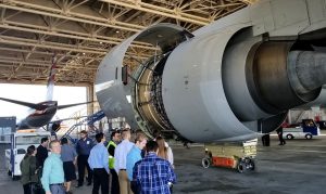 Students looking at jet engine