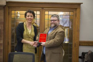 Student Advisor and Lecturer Virginia Hanson presents Freeman with a plaque for his years of service to the faculty senate. (Christopher Gannon/Iowa State University)