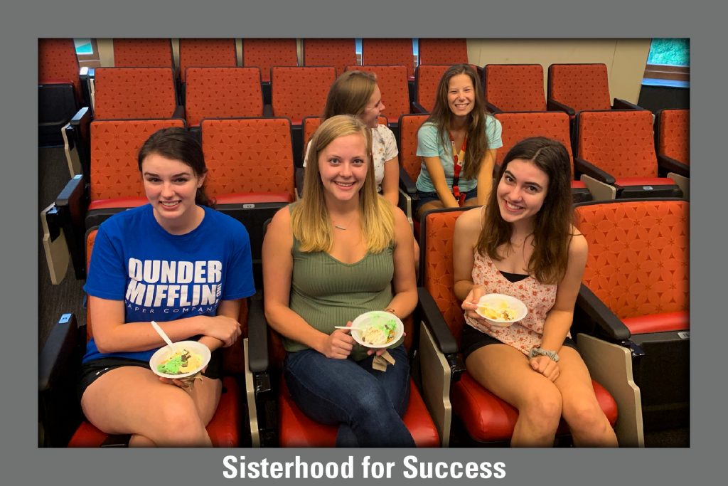 SWEster club members enjoy ice cream while sitting in theatre-style seats