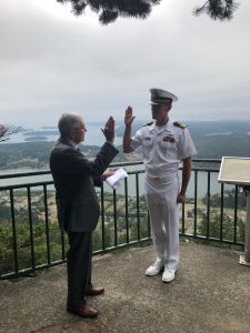 Spencer Stevens, left, reads the oath of office to his son-in-law, Matthew Letcher, right, at the ceremony in Anacortes, Washington in September.