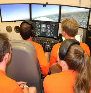 Students using flight simulator