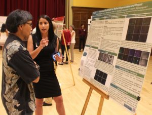 Student showing research poster