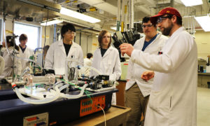 Lab superisor Ryan Arndorfer with students and lab equipment