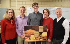 Former students poses with his classmate, instructor, and the president of Iowa State University. The group is displaying their business idea: Serona Craft Butter.